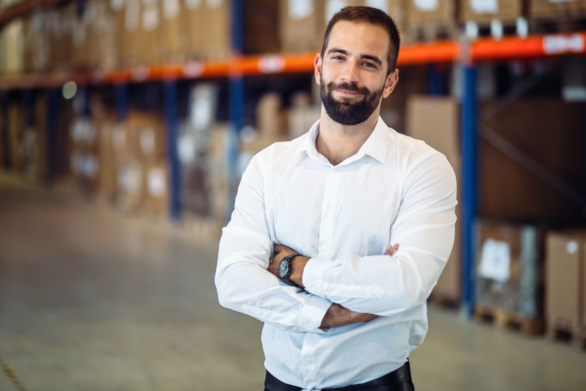 Logistics manager posing in warehouse